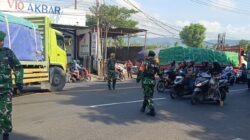 Di Bawah Terik Matahari, Prajurit Kodim 0825 Banyuwangi Tetap Berdiri Tegak Atur Lalu Lintas Pelabuhan ASDP Ketapang Dan Dermaga Bulusan
